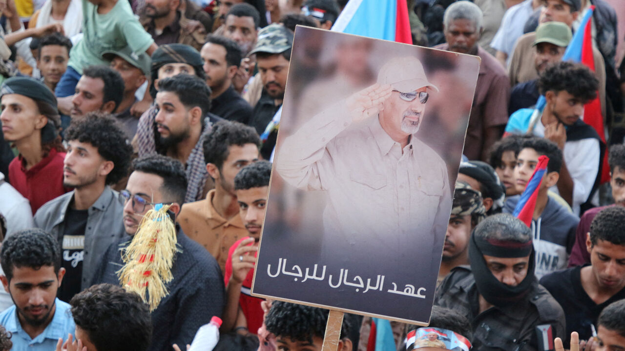 FILE PHOTO: Supporters of the UAE-backed separatist Southern Transitional Council (STC) hold a poster of Aidarous al-Zubaidi, the STC's leader, who, according to the Saudi-backed coalition, fled to an unknown destination, in Aden, Yemen, December 25, 2025. REUTERS/Fawaz Salman/File Photo
