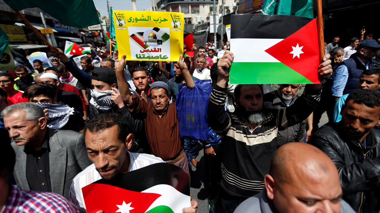 Supporters of the Muslim Brotherhood hold Jordanian flags and chant slogans during a pro-Palestinian demonstration after Friday prayers in Amman, Jordan, April 13, 2018. The placard reads: "Jerusalem our capital". REUTERS/Muhammad Hamed