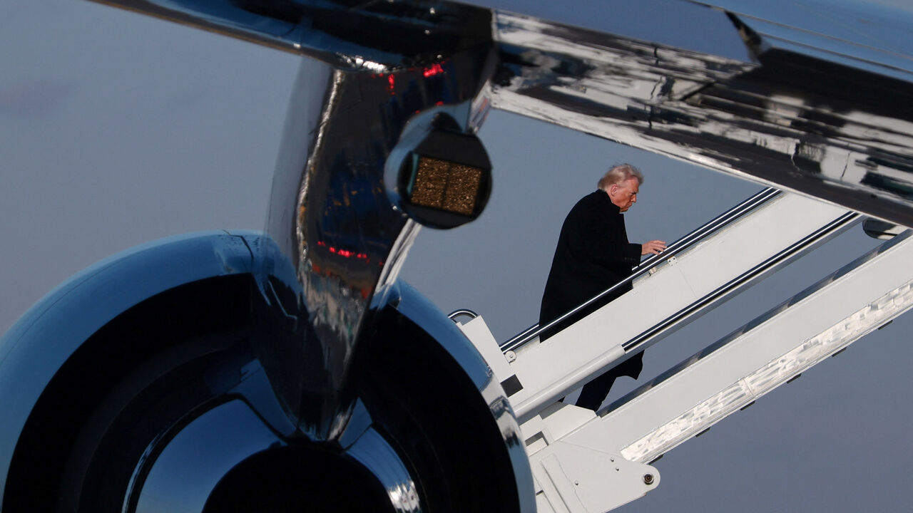 U.S.President Donald Trump boards Air Force One, at Detroit Metropolitan Wayne County Airport, in Michigan, U.S., January 13, 2026. REUTERS/Evelyn Hockstein