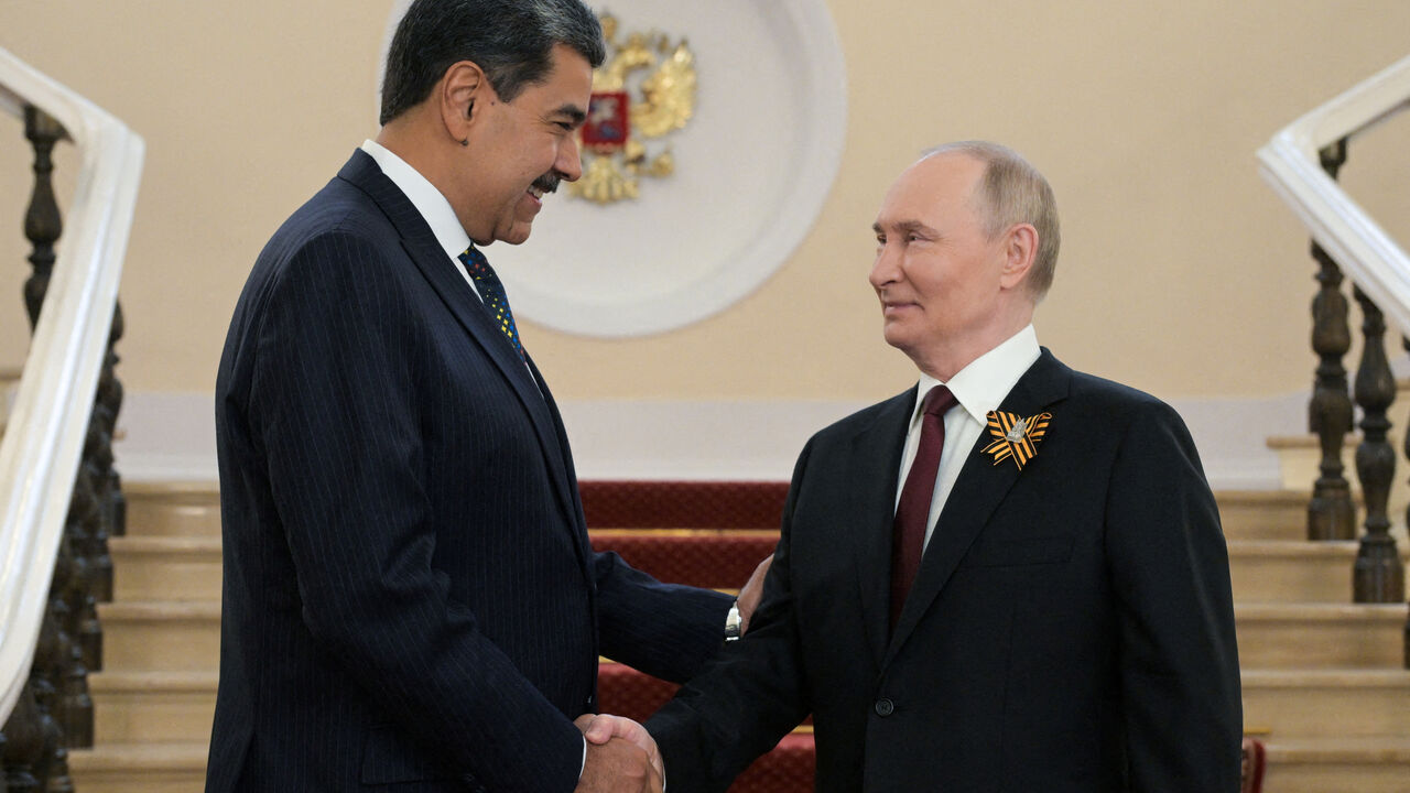 FILE PHOTO: Russia's President Vladimir Putin greets Venezuela's Nicolas Maduro before a military parade atteneded by foreign leaders on Victory Day, marking the 80th anniversary of the victory over Nazi Germany in World War Two, in Moscow, Russia, May 9, 2025. Alexei Nikolsky/Host agency RIA Novosti/Handout via REUTERS/File Photo