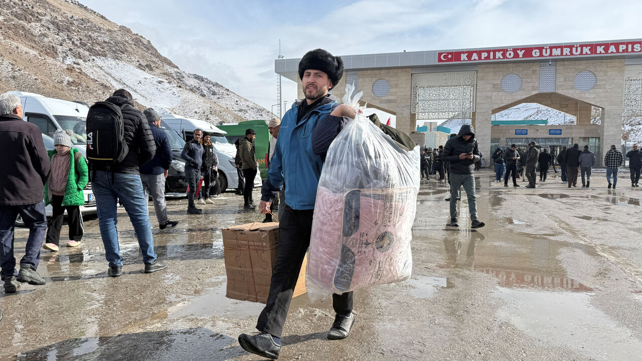 A man walks after crossing from Iran to Turkey at the Kapikoy Border Gate, in Van province, Turkey, January 14, 2026. REUTERS/Ismet Mikailogullari