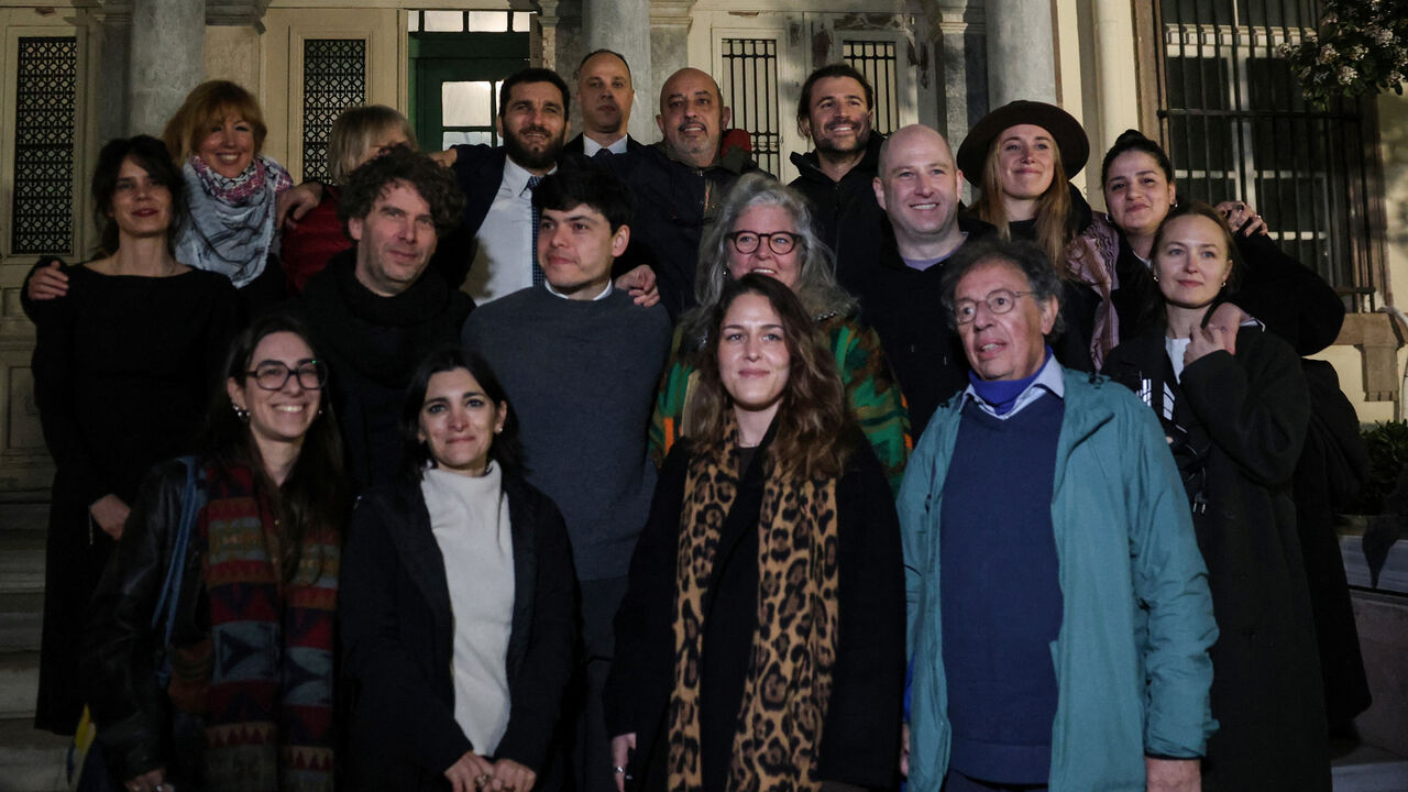Aid workers, including Sean Binder and Sarah Mardini pose with other aid workers involved in refugee rescues, after the verdict in their trial at the town of Mytilene on the island of Lesbos, Greece, January 15, 2026. REUTERS/Elias Marcou