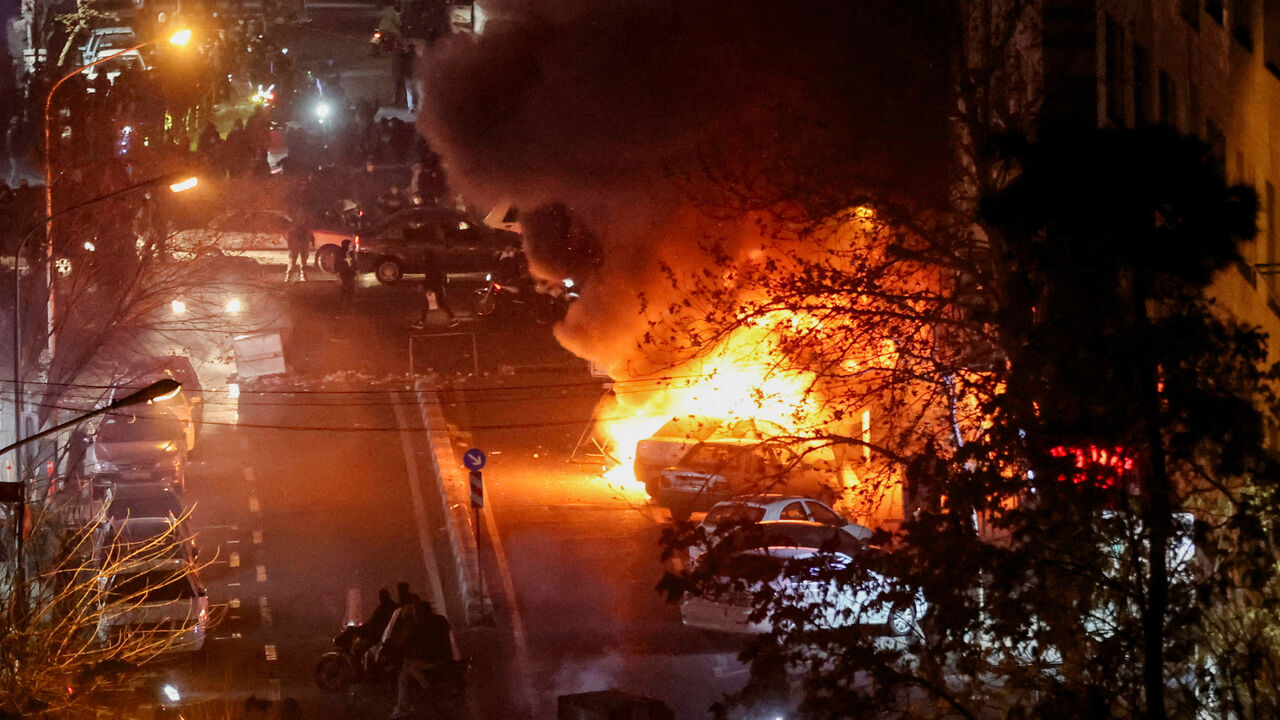 FILE PHOTO: Cars burn in a street during a protest over the collapse of the currency's value, in Tehran, Iran, January 8, 2026. Stringer/WANA (West Asia News Agency) via REUTERS/ File Photo