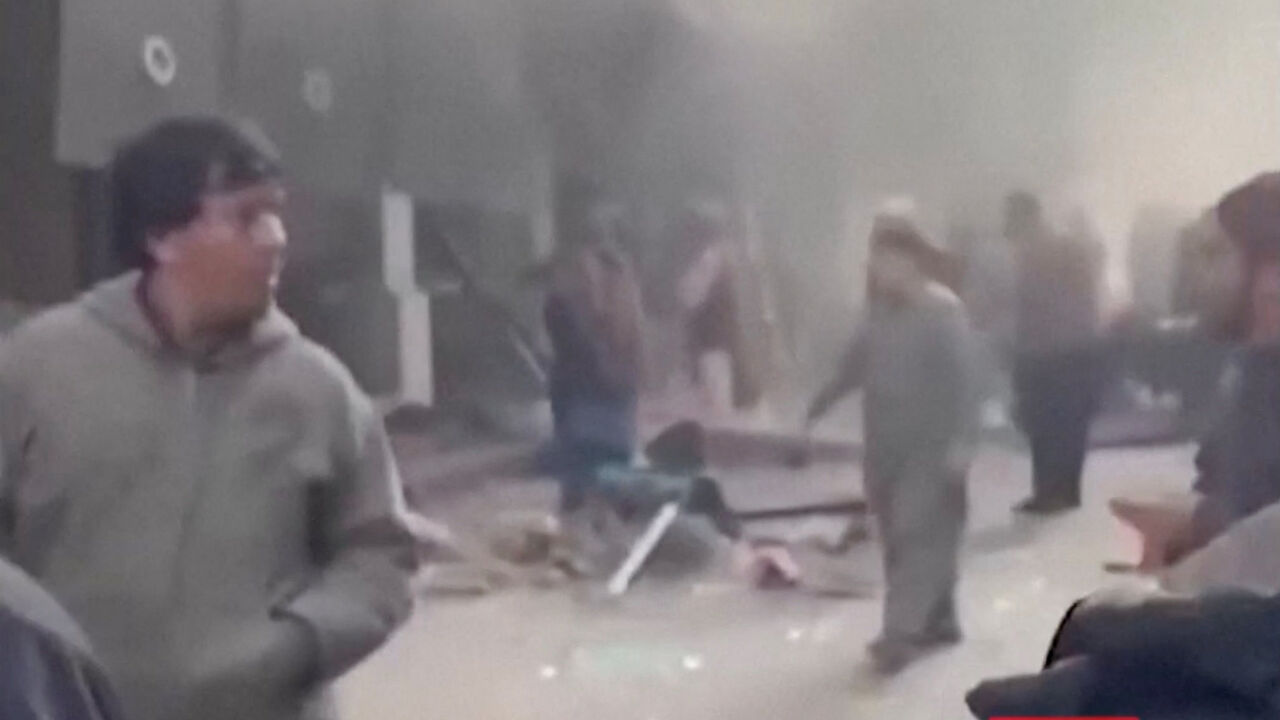 People gather amid smoke near the site following a blast at a Chinese-run restaurant, in Kabul, Afghanistan, January 19, 2026 in this screengrab taken from a handout video.  TOLOnews via FACEBOOK/Handout via REUTERS