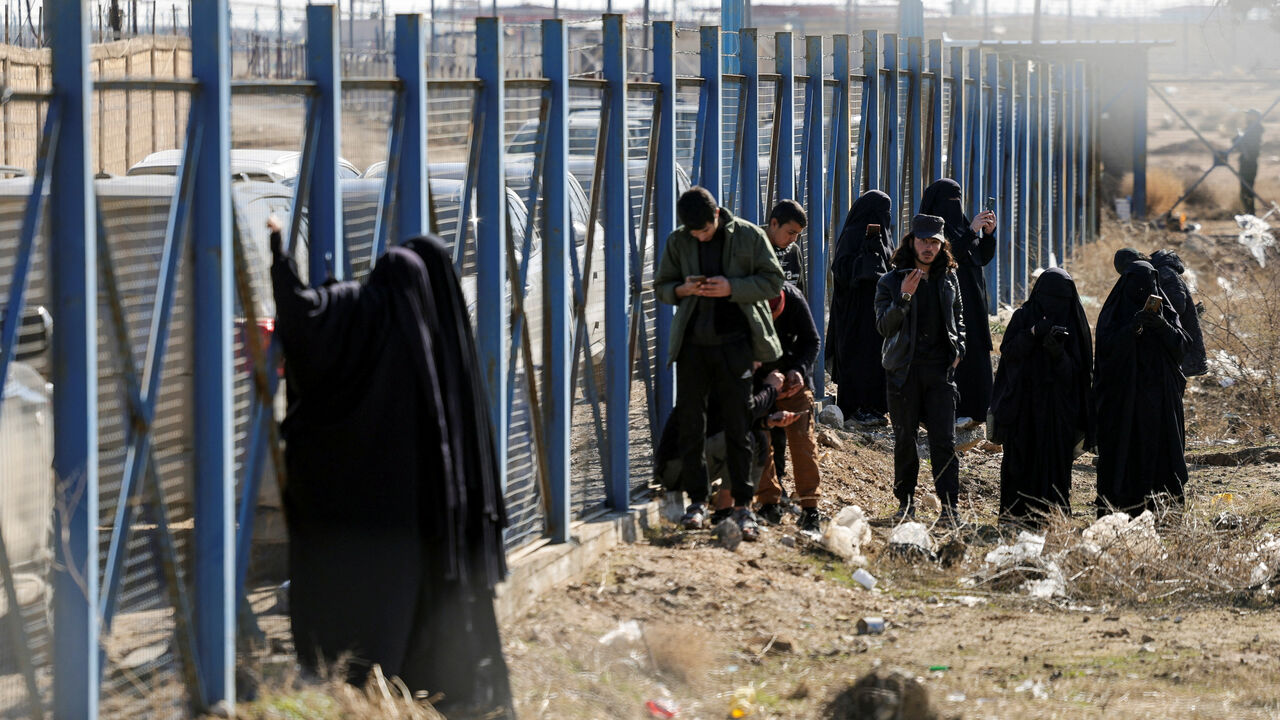 A group of detainees gather at al-Hol camp after the Syrian government took control of it following the withdrawal of Syrian Democratic Forces (SDF), in Hasaka, Syria, January 21, 2026. REUTERS/Khalil Ashawi