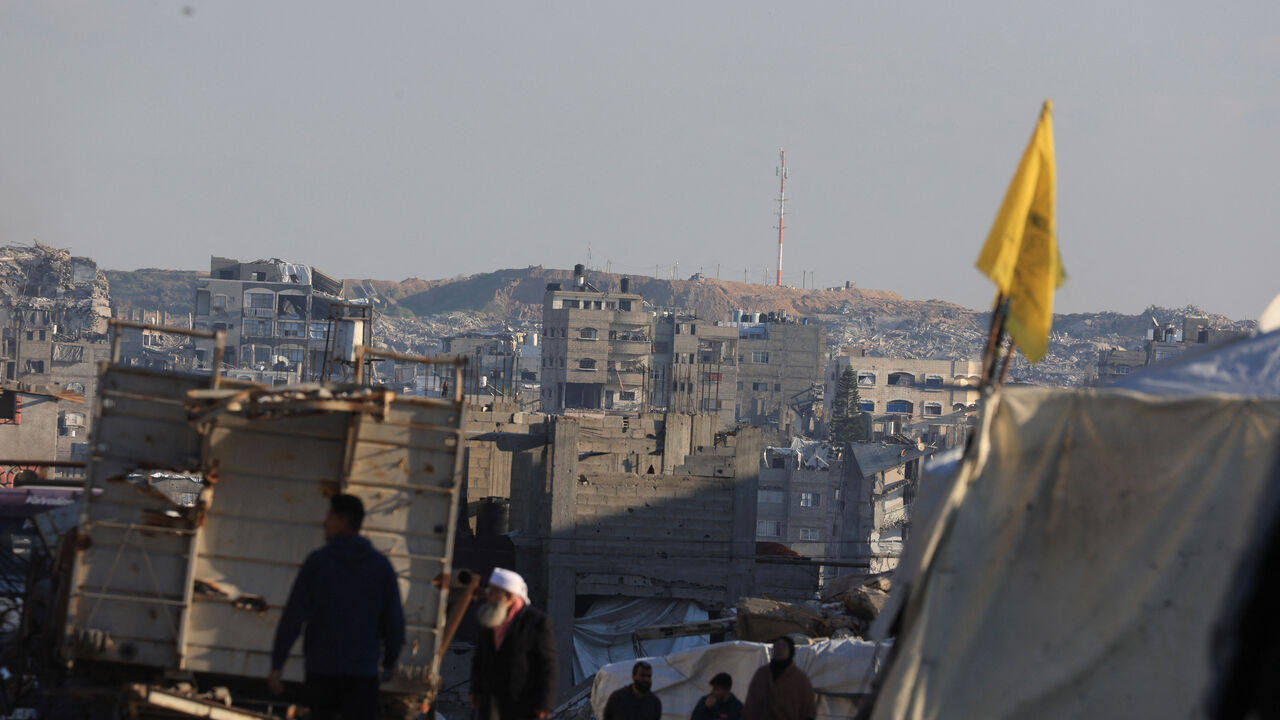 Displaced Palestinian people walk near the area marked as 'Yellow Line' by the Israeli military, in east of Gaza City, January 16, 2026. REUTERS/Dawoud Abu Alkas