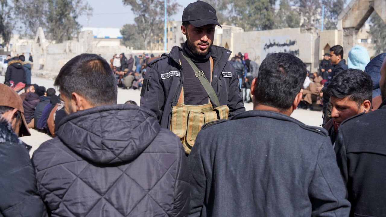 Members of the Kurdish-led Syrian Democratic Forces (SDF) queue to settle their status with Syrian government in Raqqa, Syria January 27, 2026. REUTERS/Karam al-Masri
