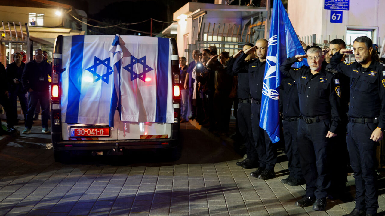 Police officers salute as the vehicle carrying the body of Israeli police officer, and the last hostage Ran Gvili, kidnapped in the October 7, 2023, Hamas attack, arrives to the Institute of Forensic Medicine after being found and identified in the Gaza Strip, according to the statement by the Israeli military, in Tel Aviv, Israel, January 26, 2026. REUTERS/Amir Cohen