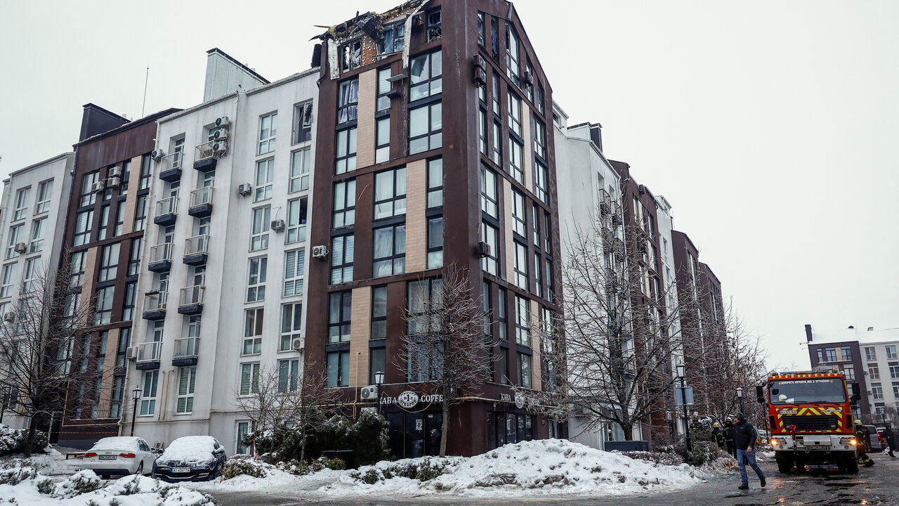 An emergency service truck stands next to an apartment building, which was hit during overnight Russian drone strikes in the town of Bilohorodka, amid Russia's attack on Ukraine, in the Kyiv region, Ukraine, January 28, 2026. REUTERS/Alina Smutko