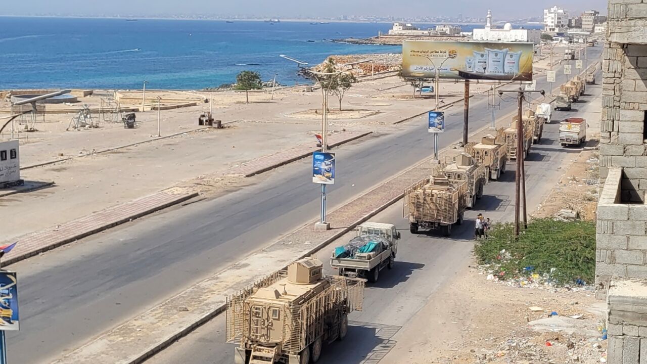 A convoy of armoured vehicles makes its way along a street in southern Yemen on January 1