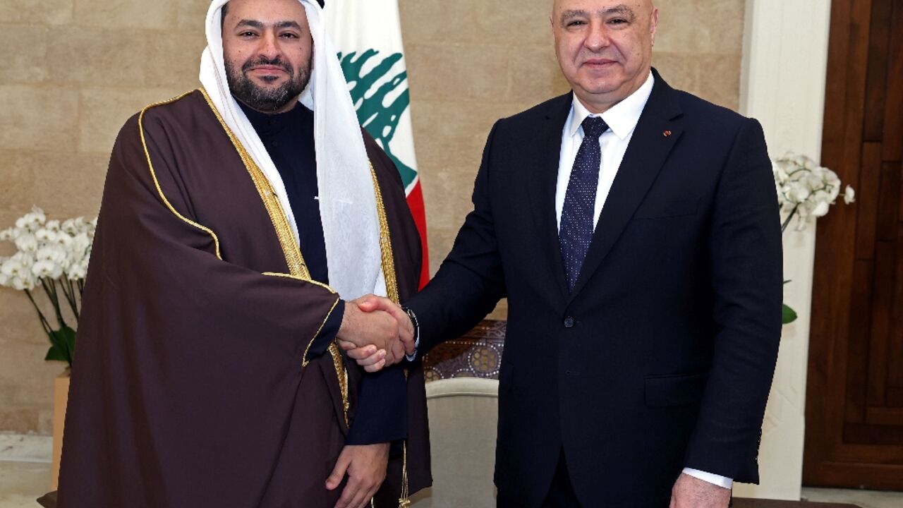 This handout photograph released by the Lebanese Presidency Press Office shows Lebanese President Joseph Aoun shaking hands with Qatari Minister of State Mohammed Bin Abdulaziz al-Khulaifi