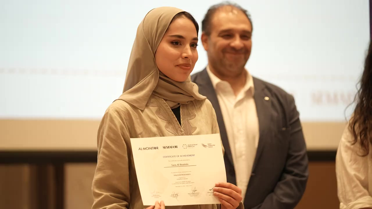 Student holding certificate