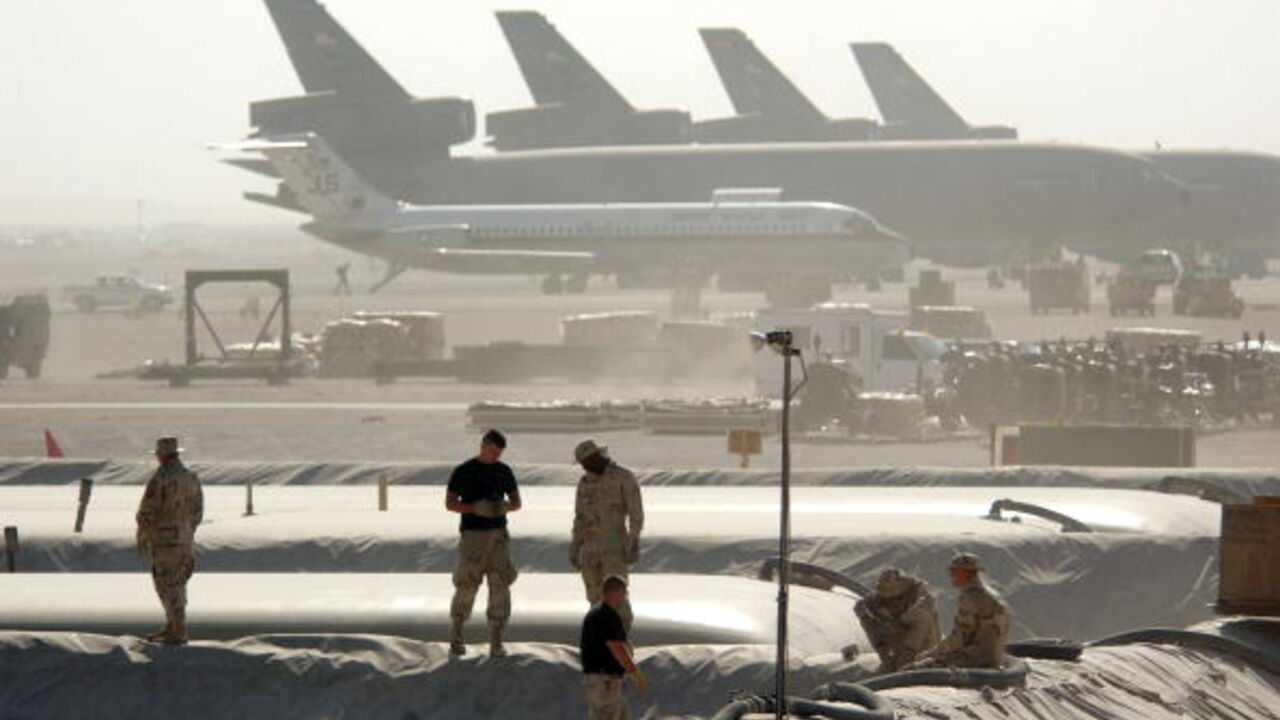 AL UDEID, QATAR - DECEMBER 30: Members of the Petroleum Oils and Lubricants (POL) squadron at the 379th Air Expeditionary Wing take a break from replacing a 50,000-gallon fuel bladder in support of Operation Enduring Freedom December 30, 2002 in Al Udeid, Qatar. The POL squadron recently had to replace 11 of their 20 fuel bladders due to notification of a bad lot number. (Photo by Cherie A. Thurlby/USAF/Getty Images)