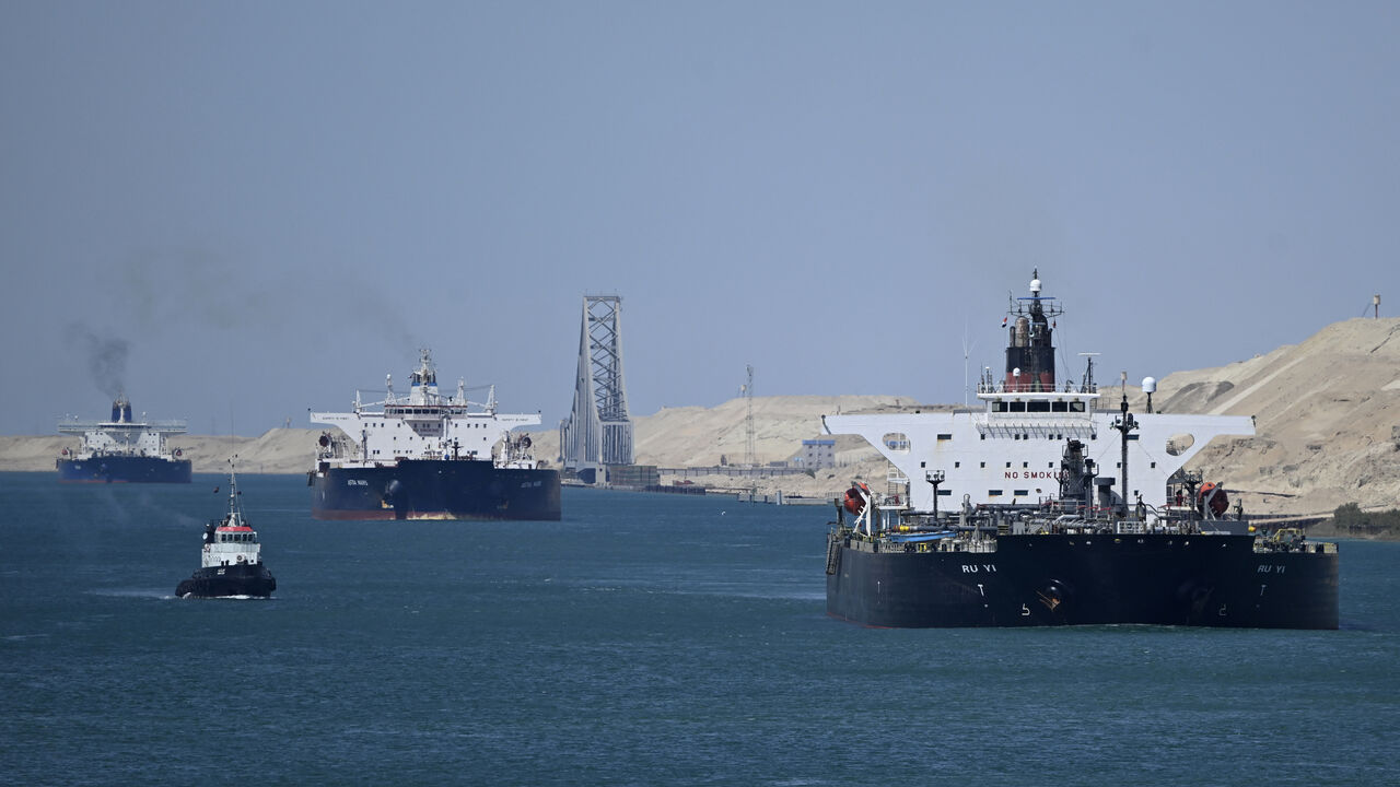 Ships sail along Egypt's Suez Canal near Ismailia on April 16, 2025. 
