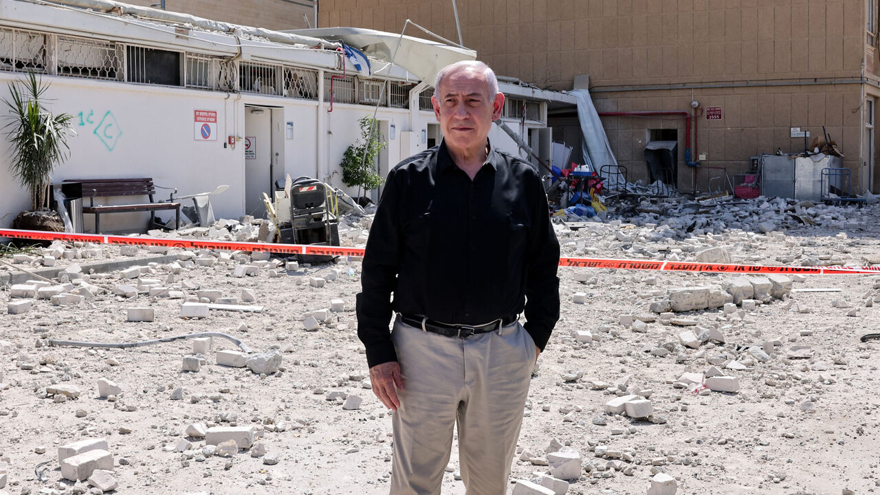 Israeli Prime Minister Benjamin Netanyahu stands amid debris outside the Soroka Hospital after it was hit by a missile fired from Iran, Beersheba, Israel, June 19, 2025.