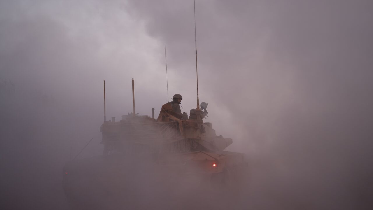 An Israeli soldier rides in the army Merkava main battle tank at a position in northern Israel along the border with southern Lebanon, Nov. 6, 2025, when Israel struck Hezbollah targets in southern Lebanon.