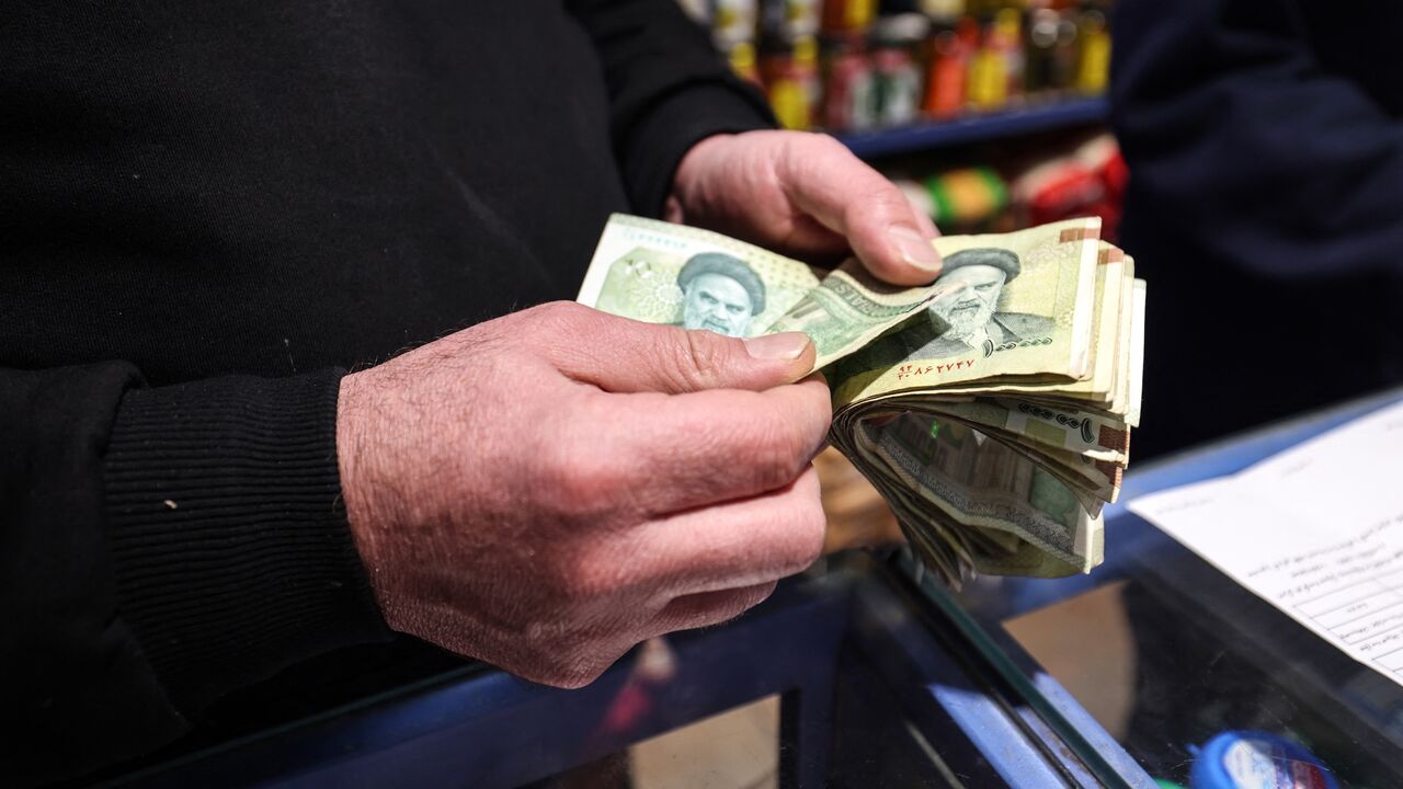 A shop owner counts Iranian banknotes at a store in the capital Tehran on Jan. 7, 2026. 