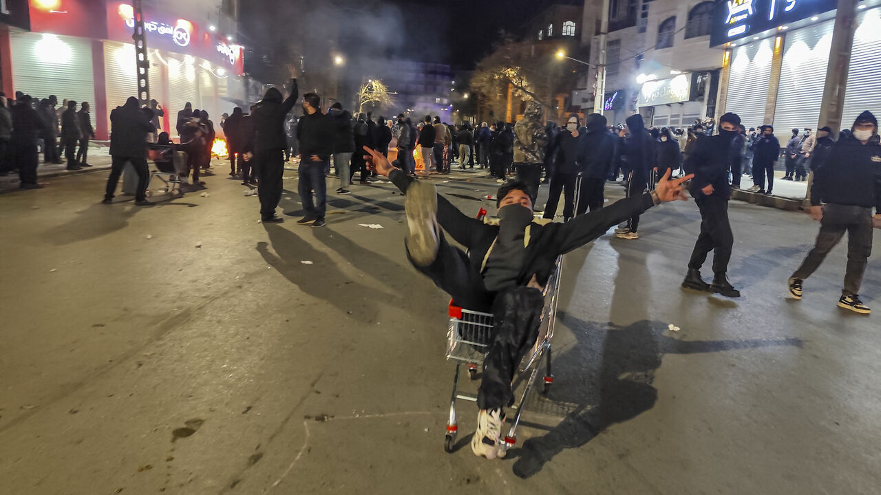 Iranians gather while blocking a street during a protest in Kermanshah, Iran on January 8, 2026. The nationwide protests started in Tehran's Grand Bazaar against the failing economic policies in late December, which spread to universities and other cities, and included economic slogans, to political and anti-government ones. (Photo by Kamran / Middle East Images / AFP via Getty Images)
