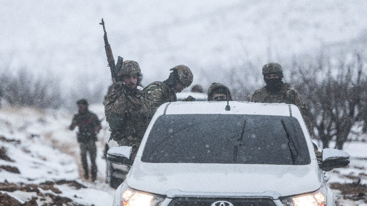 Syrian soldiers make their way through the country's mountainous Qalamoun region, near the border with Lebanon, on January 1, 2026
