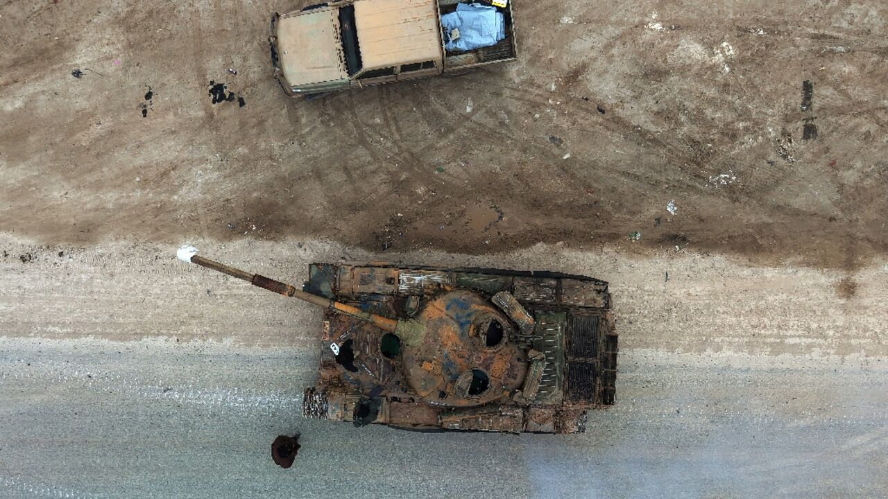 This aerial photograph shows a Syrian army tank waiting to enter the town of Deir Hafer