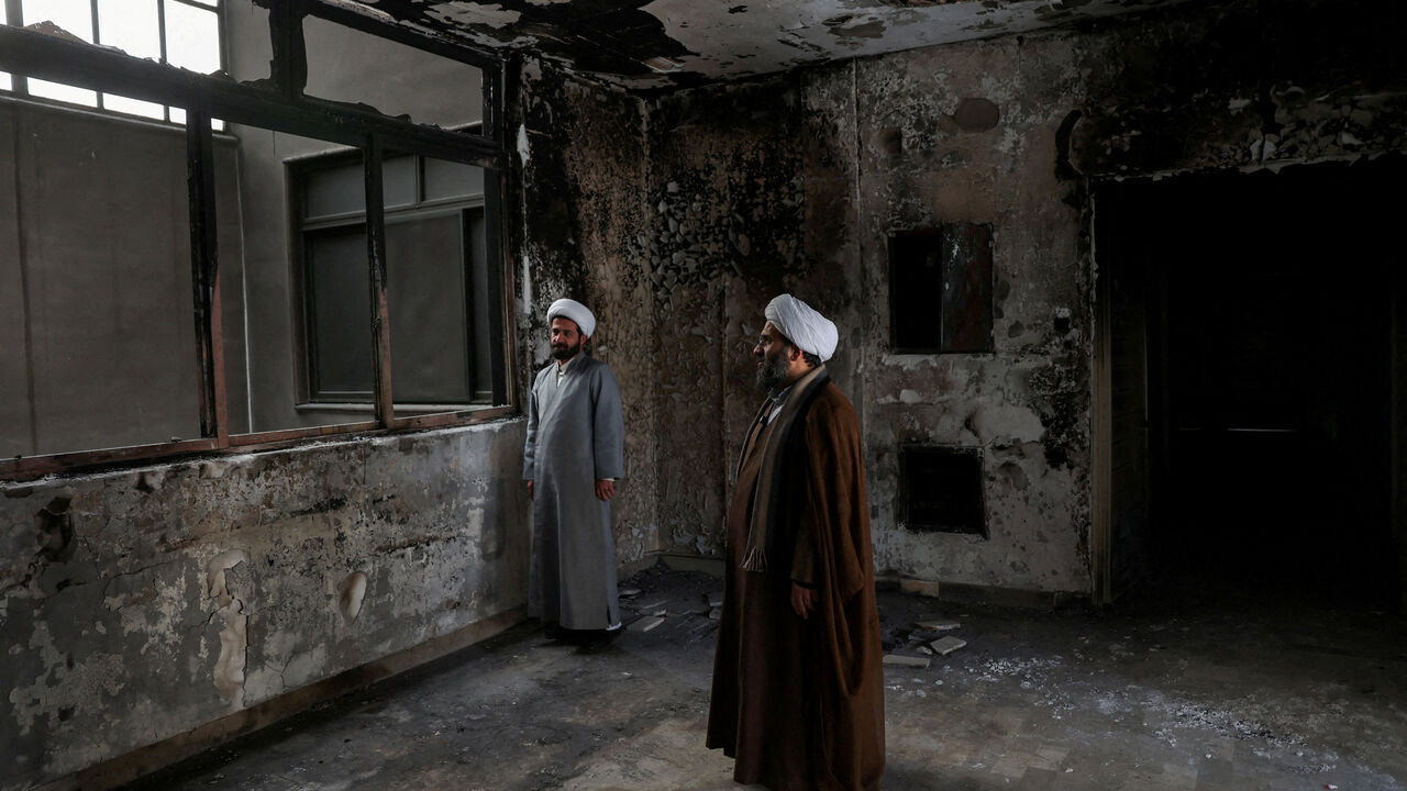 FILE PHOTO: Iranian clerics stand in the Islamic seminary that was burned during Iran's protests, in Tehran, Iran, January 21, 2026. Majid Asgaripour/WANA (West Asia News Agency) via REUTERS/File Photo