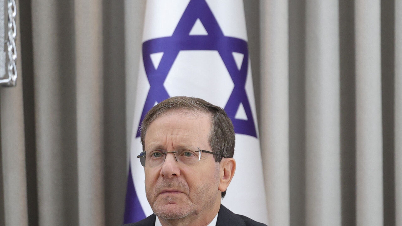 Israeli President Isaac Herzog looks on during a meeting with German Chancellor Friedrich Merz at the President's residence in Jerusalem, December 6, 2025.    Abir Sultan/Pool via REUTERS