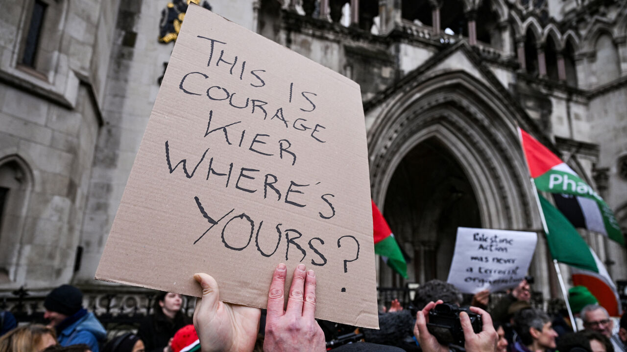 A protester holds a sign with a message against British Prime Minister Keir Starmer outside the High Court, after judges ruled the British government’s decision to designate pro‑Palestinian group Palestine Action as a terrorist organisation unlawful, in London, Britain, February 13, 2026. REUTERS/Jaimi Joy