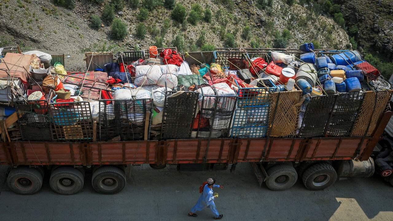 A man walks past a truck loaded with belongings of Afghan nationals, as they head back to Afghanistan after Pakistan started to deport documented Afghan refugees, near Torkham border crossing between Pakistan and Afghanistan, September 1, 2025. REUTERS/Fayaz Aziz
