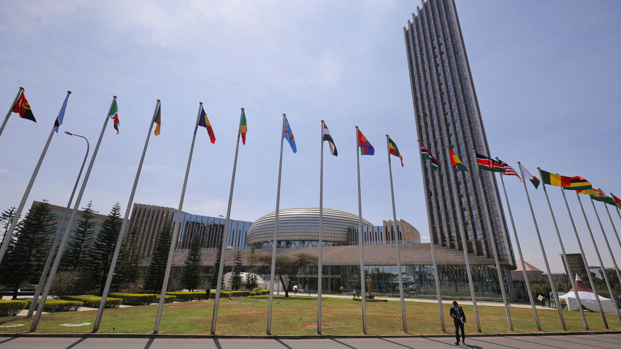 FILE PHOTO: A delegate walks next to African Union (AU) member states flags ahead of the 38th Ordinary Session of the Heads of State and Government of the African Union at the African Union Commission (AUC) headquarters in Addis Ababa, Ethiopia, February 14, 2025. REUTERS/ Tiksa Negeri/File Photo