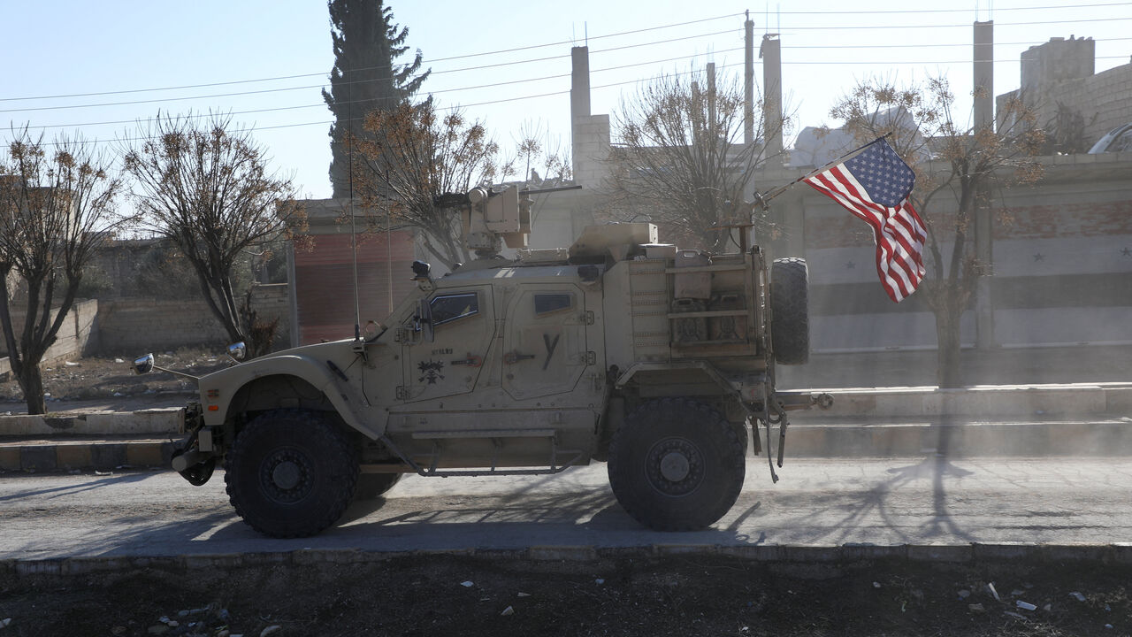 FILE PHOTO: A U.S. military vehicle moves on a road on the day of a meeting between the Syrian Democratic Forces (SDF) leaders and U.S. military leaders, in Deir Hafer, Syria. January 16, 2026. REUTERS/Orhan Qereman/ File Photo