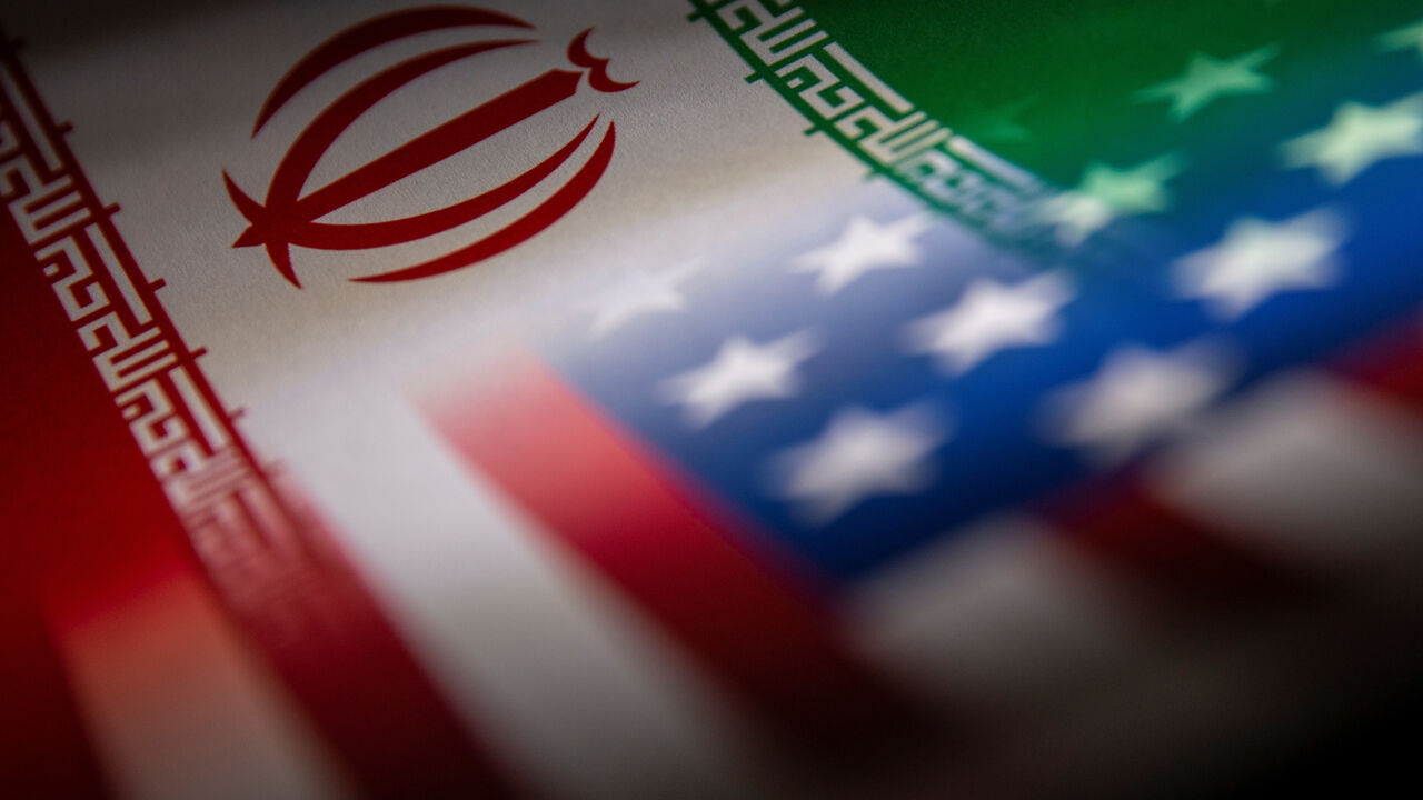 Iran's and U.S.' flags are seen printed on paper in this illustration taken January 27, 2022. REUTERS/Dado Ruvic/Illustration