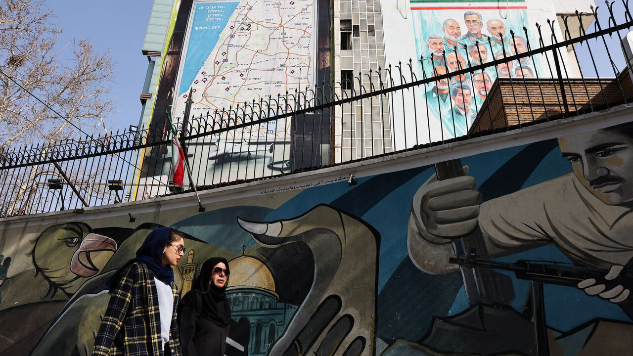 Iranian women walk past an anti-Israeli billboard in Tehran, Iran, February 19, 2026. Majid Asgaripour/WANA (West Asia News Agency) via REUTERS