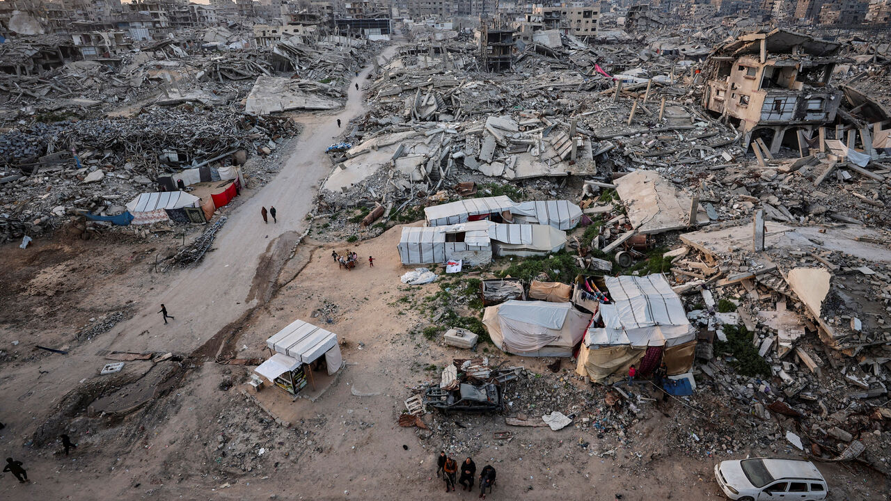 Palestinians gather near the rubble of residential buildings destroyed during the two-year Israeli offensive, on the first day of the holy month of Ramadan, in Gaza City, February 18, 2026. REUTERS/Dawoud Abu Alkas