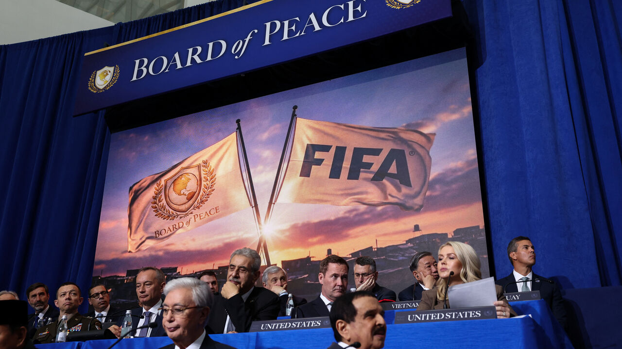 A screen displays an image of FIFA and Board of Peace flags, during the inaugural Board of Peace meeting at the U.S. Institute of Peace in Washington, D.C., U.S., February 19, 2026. REUTERS/Kevin Lamarque