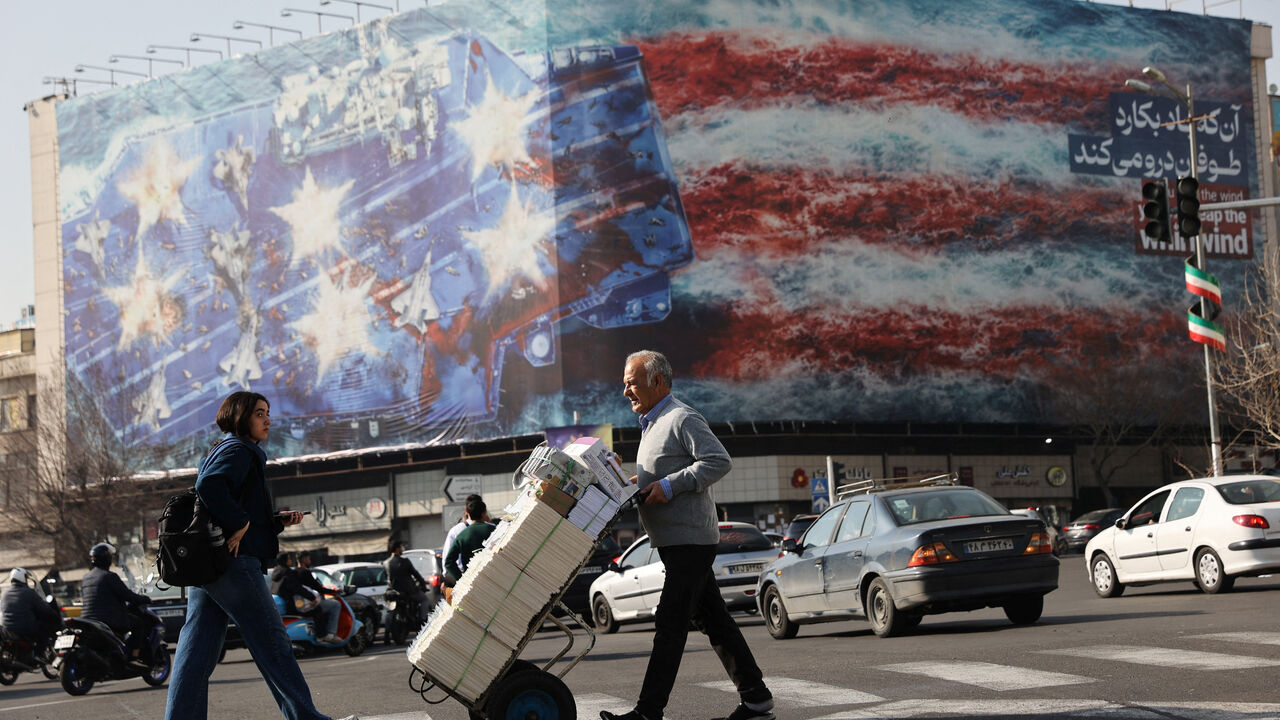 People walk past an anti-U.S. billboard in Tehran, Iran, February 19, 2026. Majid Asgaripour/WANA (West Asia News Agency) via REUTERS