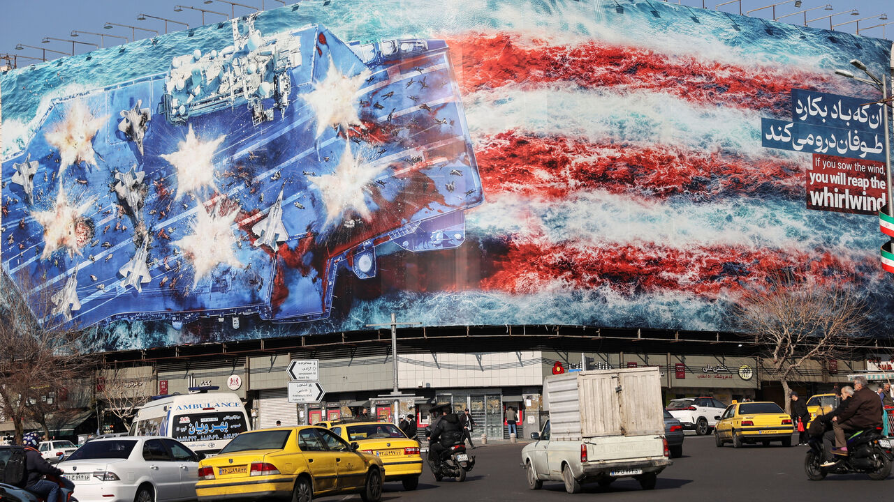 People walk past an anti-U.S. billboard on a street in Tehran, Iran, February 17, 2026. Majid Asgaripour/WANA (West Asia News Agency) via REUTERS