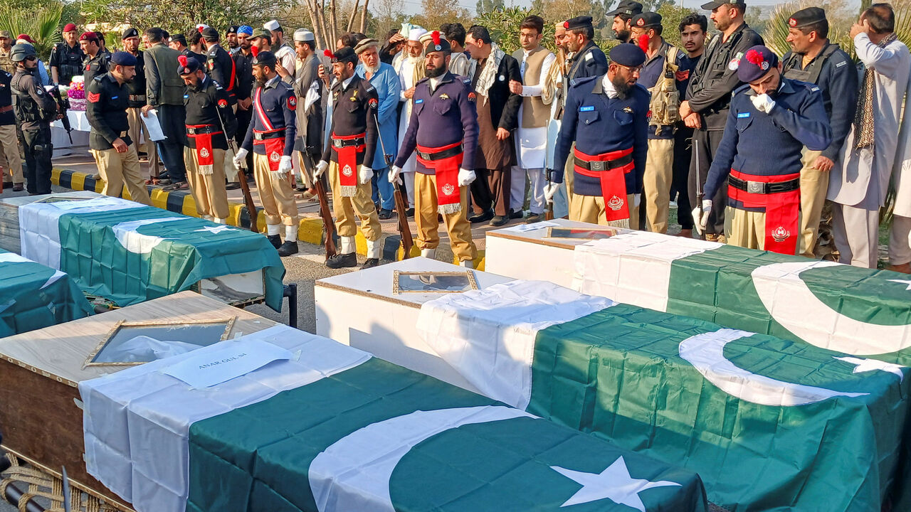 Police officers and residents gather beside Pakistani flag-draped coffins of police officers who were killed following a terrorist attack on a police vehicle, during a funeral in Kohat, in Khyber Pakhtunkhwa province, Pakistan, February 24, 2026. REUTERS/Syed Basit