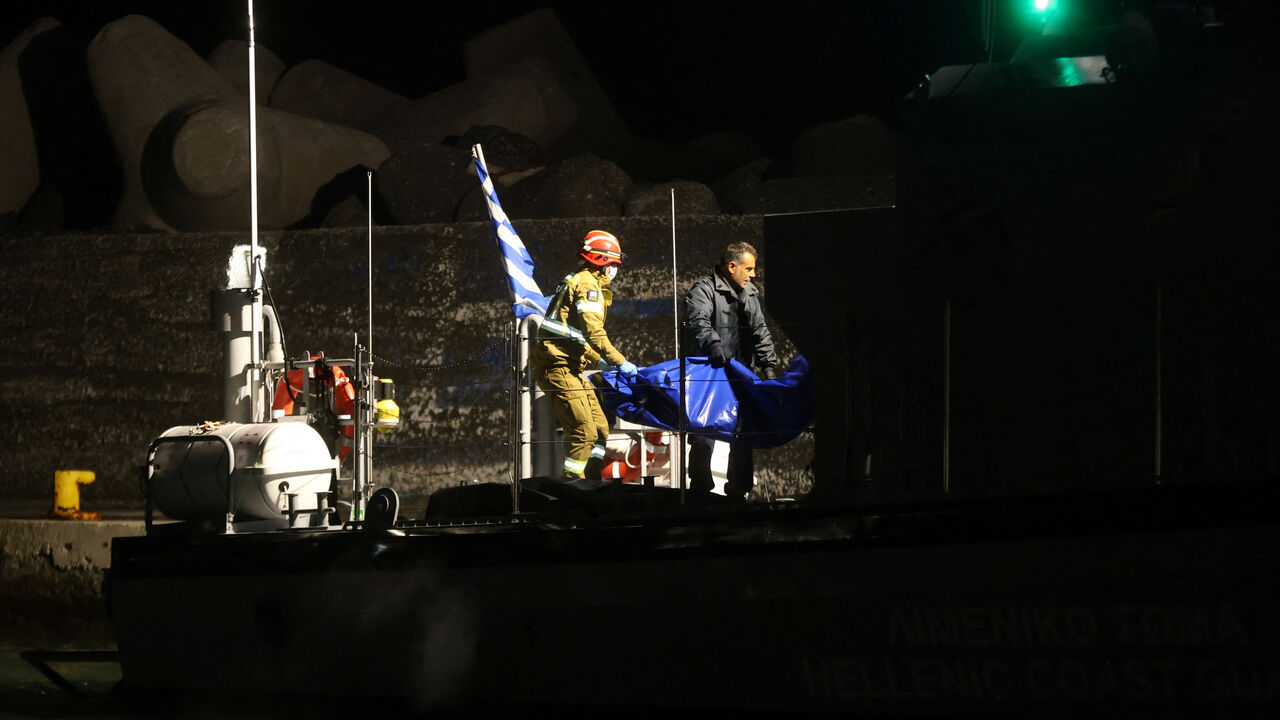 Coast guards carry bags with the bodies of  drowned migrants, following a shipwreck off the tiny southern Greek island of Chrysi, in the port of Ierapetra, Crete island, Greece, December 6, 2025. REUTERS/Stefanos Rapanis/File Photo