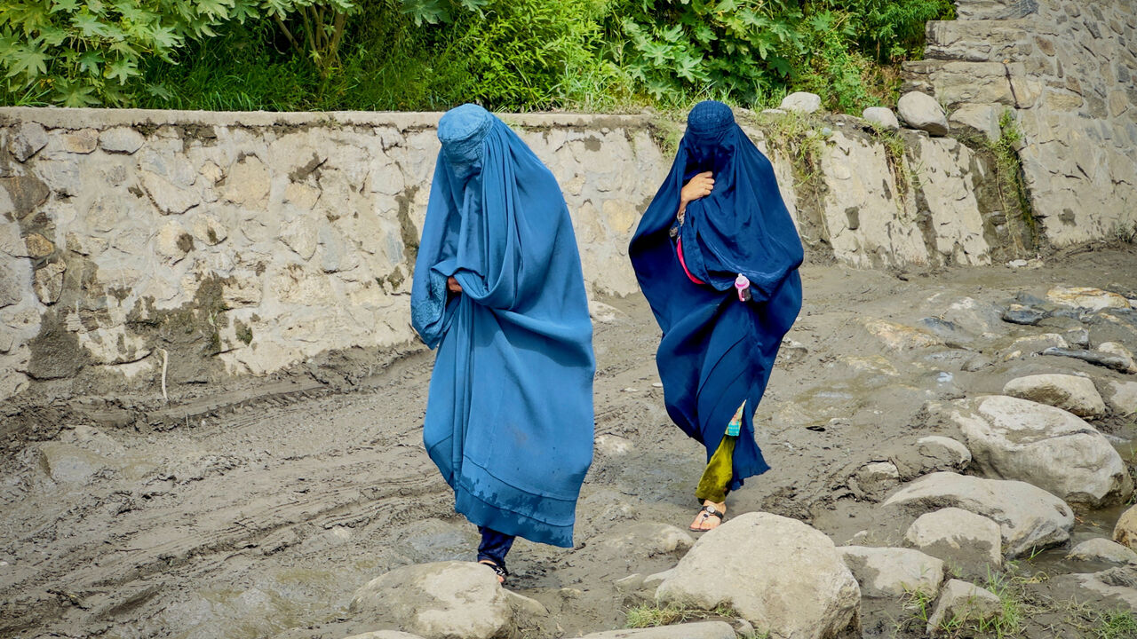 FILE PHOTO: Afghan women in burqa walk towards a safer place after their house was damaged following a deadly magnitude 6 earthquake that struck Afghanistan on Sunday, at Lulam village, in Nurgal district, Kunar province, Afghanistan, September 3, 2025. REUTERS/Sayed Hassib/File Photo