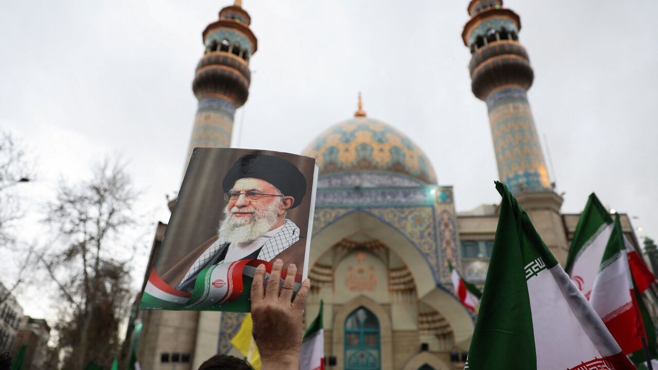 A person holds an image of  Iran's Supreme Leader Ayatollah Ali Khamenei  as Iranian demonstrators protest against the U.S.-Israeli strikes, in Tehran, Iran, February 28, 2026. Majid Asgaripour/WANA (West Asia News Agency) via REUTERS