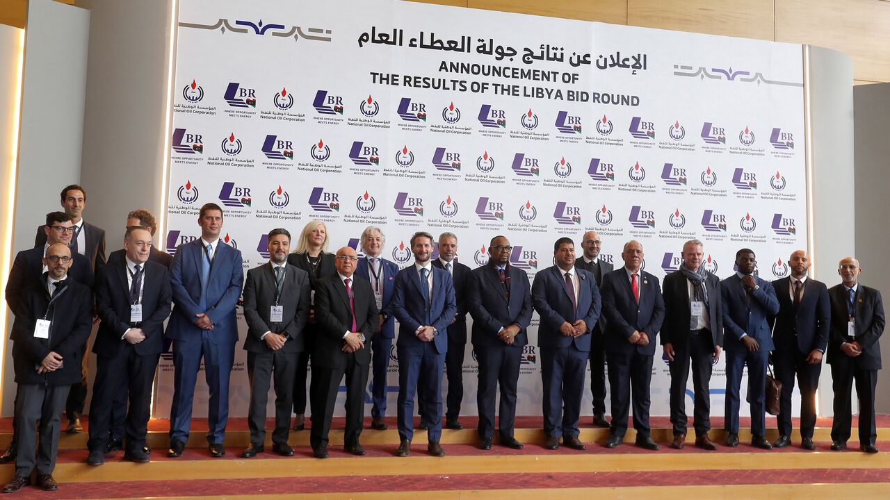Masoud Suleman, acting chairman of Libya's National Oil Corporation, and other corporate representatives pose for a photo during a conference announcing the first new grants of oil exploration and production licenses in 17 years, in Libya's capital, Tripoli, on Feb. 11, 2026. 