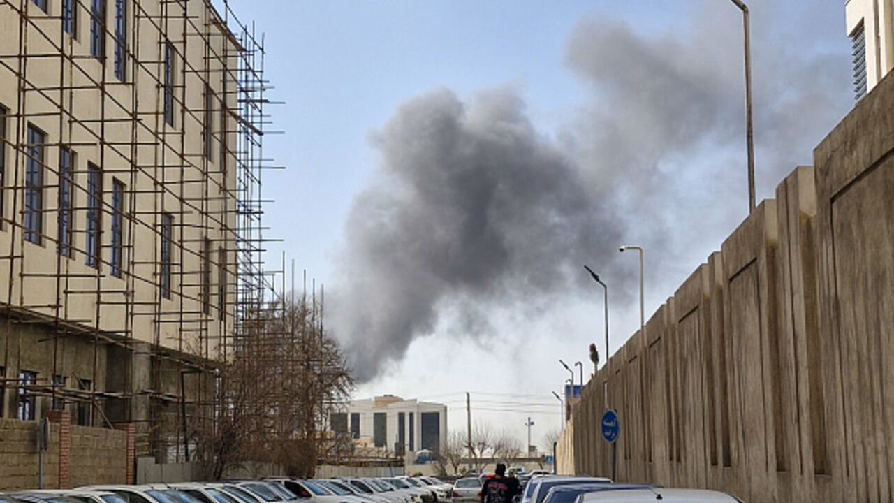 A plume of smoke rises over Tehran after a reported explosion on February 28, 2026, after Israel said it carried out a "preemptive strike" on Iran as sirens sounded in Jerusalem and phone alerts warned of an "extremely serious" threat. (Photo by Ehsan / Middle East Images / AFP via Getty Images)