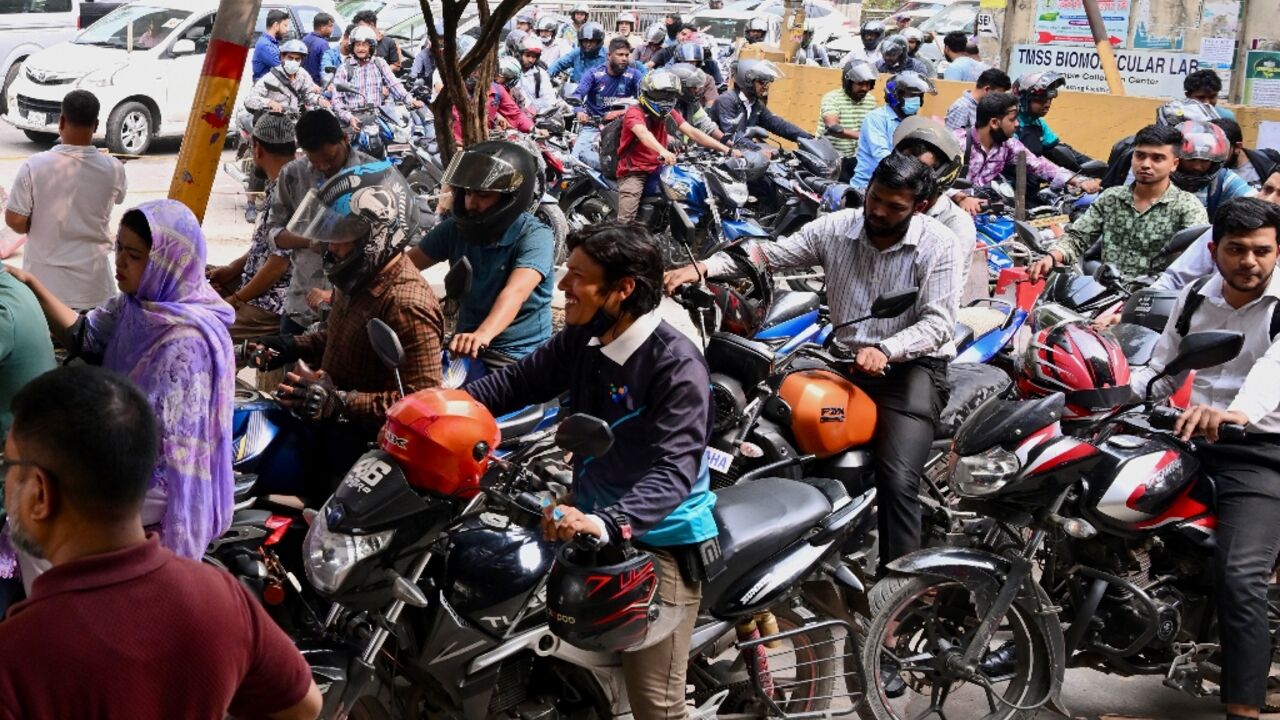 People queue up to refuel their motorbikes at a gas station in Dhaka. Around seven million Bangladeshis work overseas -- the majority in the Middle East, with Saudi Arabia hosting around two-thirds of the total