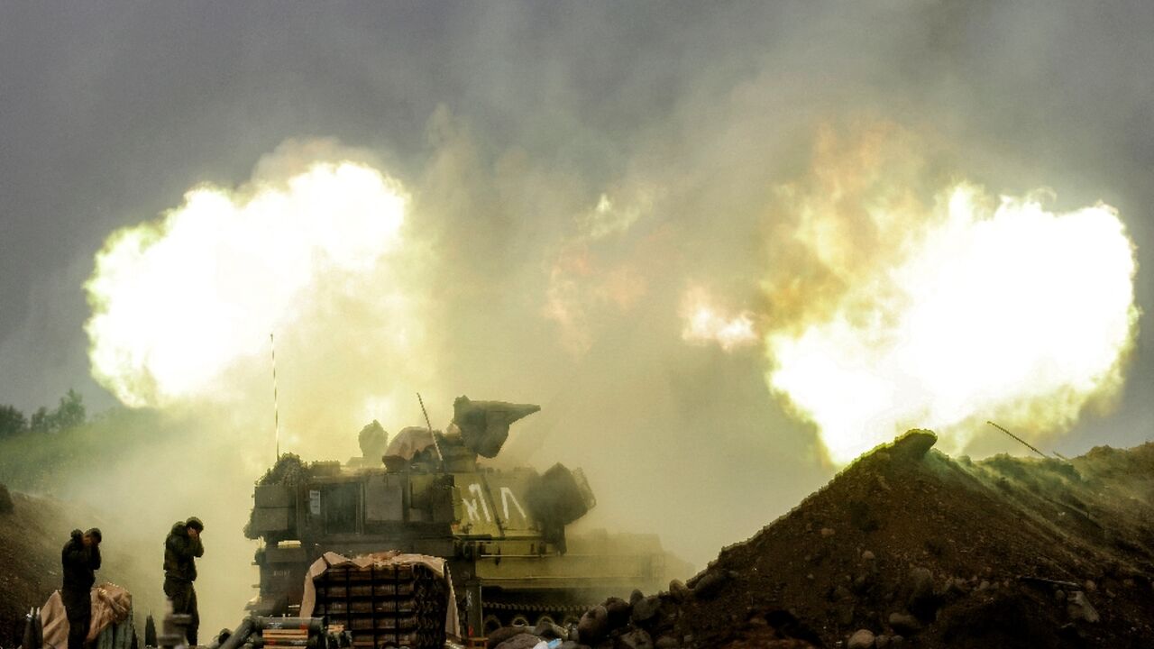 An Israeli self-propelled howitzer artillery gun fires rounds towards southern Lebanon