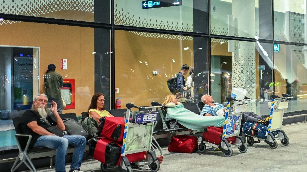 Stranded passengers wait at the Velana International Airport in Male on March 1, 2026 after the cancellation of flights destined for the Middle East