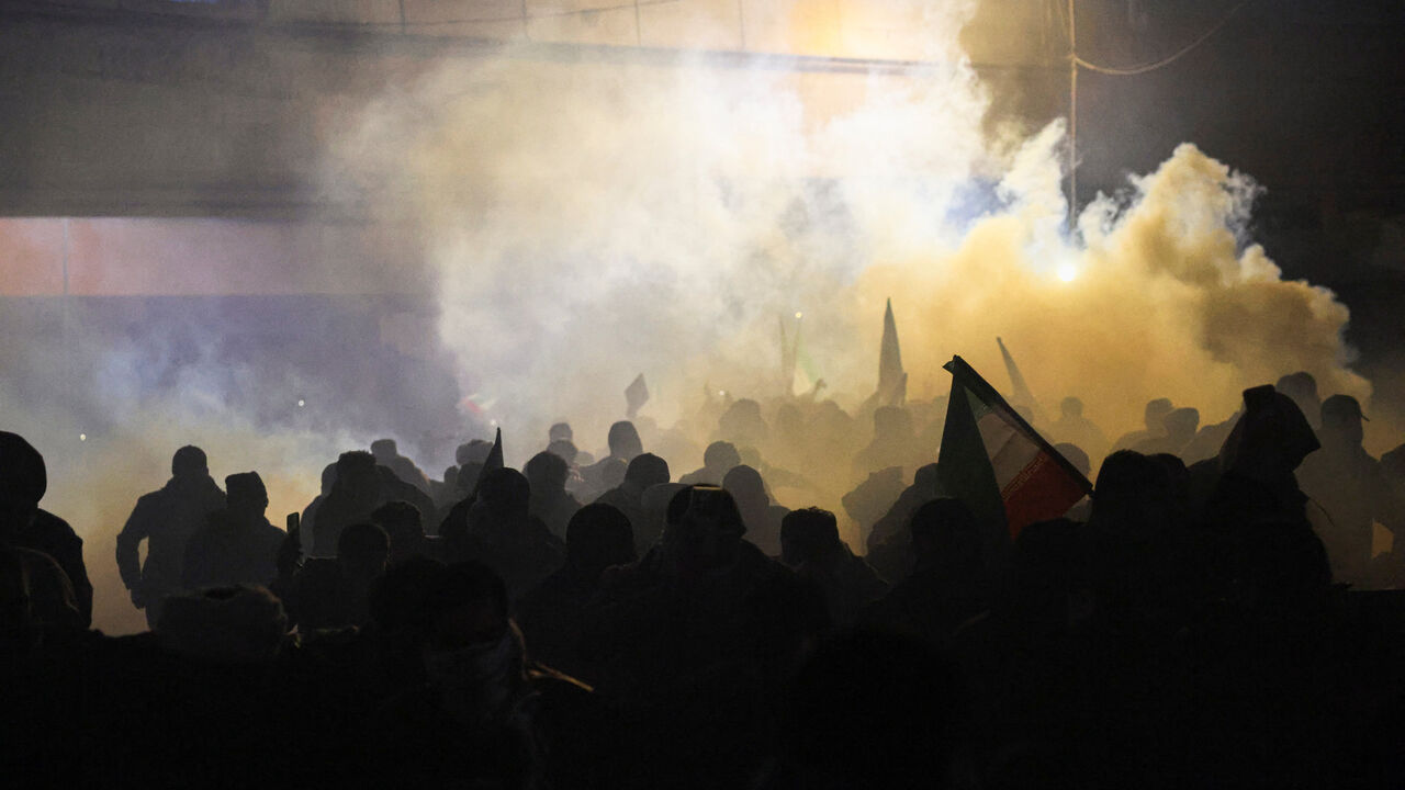 Protesters supporting Iraqi Shi'ite armed groups react to tear gas as they attempt to move toward the U.S. embassy located in Baghdad's Green Zone, as riot police deploy to block their advance, following the Israel and U.S. strikes on Iran and the killing of Iran's Supreme Leader Ayatollah Ali Khamenei, in Baghdad, Iraq, March 1, 2026. REUTERS/Ahmed Saad