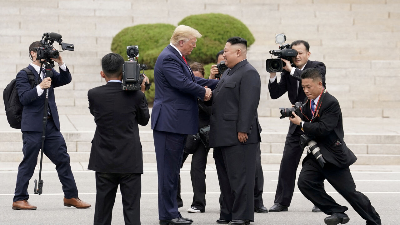 FILE PHOTO: U.S. President Donald Trump meets with North Korean leader Kim Jong Un at the demilitarized zone separating the two Koreas, in Panmunjom, South Korea, June 30, 2019. REUTERS/Kevin Lamarque/File Photo