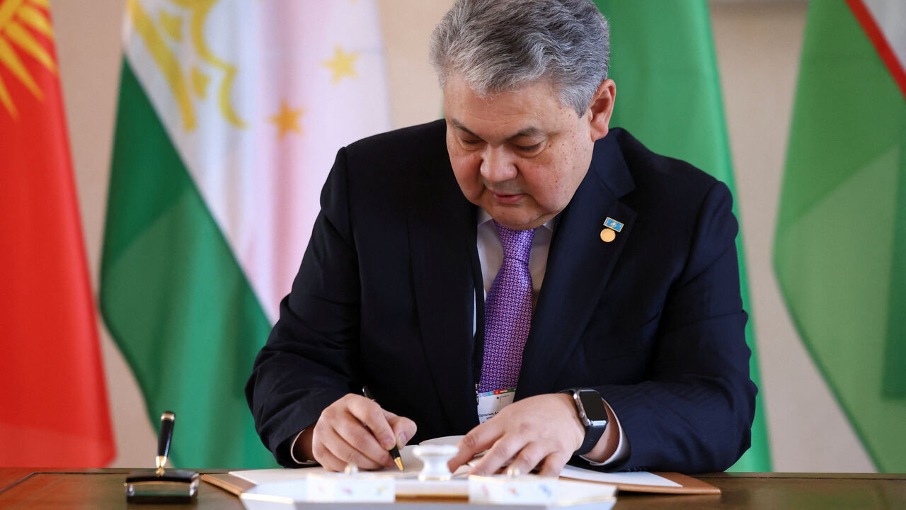 The foreign minister of Kazakhstan, Yermek Kosherbayev, signs a guestbook at Bellevue Palace in Berlin, Germany, February 11, 2026. REUTERS/Christian Mang