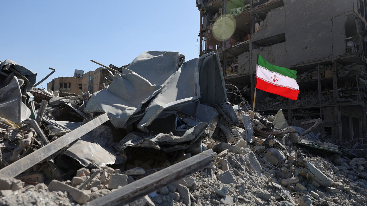 The national flag of Iran flies in the wind as debris lies scattered in the aftermath of an Israeli and U.S. strike on a police station, amid the U.S.-Israeli conflict with Iran, in Tehran, Iran, March 3, 2026. Majid Asgaripour/WANA (West Asia News Agency) via REUTERS