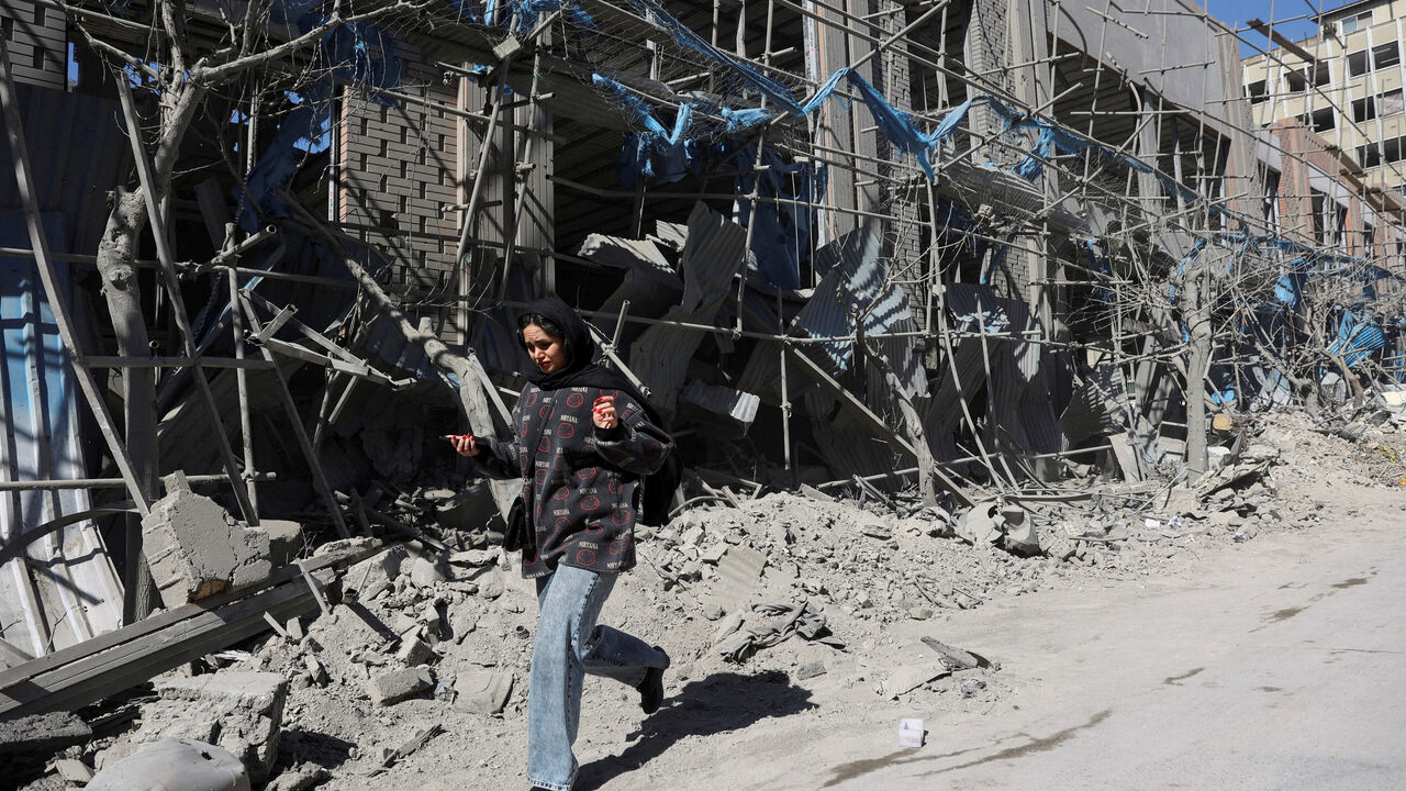 A woman walks on the street following an Israeli and U.S. strike on a police station, amid the U.S.-Israeli conflict with Iran, in Tehran, Iran, March 3, 2026. Majid Asgaripour/WANA (West Asia News Agency) via REUTERS